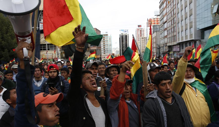 Coca leaf producers march against the reelection of President Evo Morales, in La Paz, Bolivia, Tuesday, Oct. 29, 2019. Morales&#39; backers and foes are blocking streets and highways across the country in a dispute over official election results that show the leftist leader winning reelection without a runoff. (AP Photo/Juan Karita)