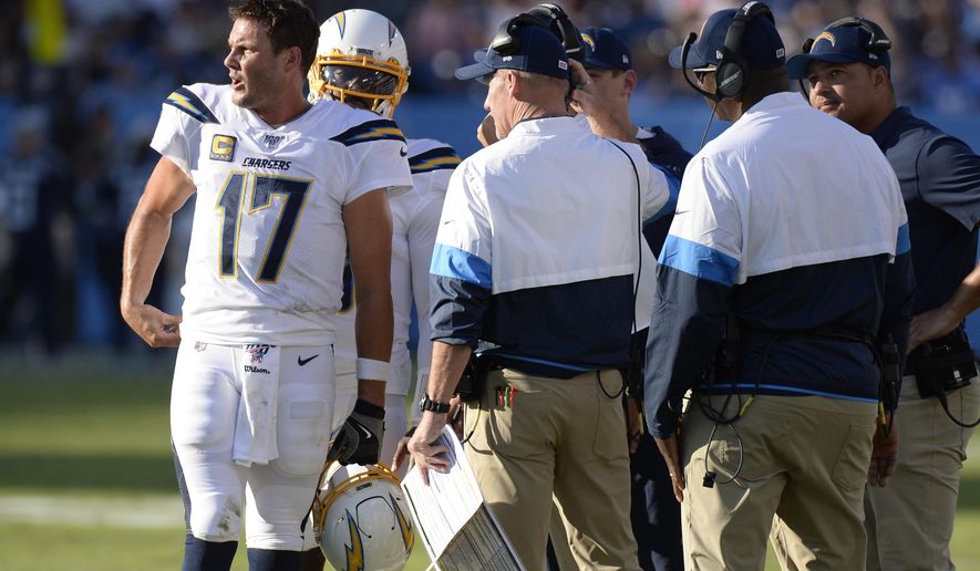 Los Angeles Chargers quarterback Philip Rivers (17) talks with coaches in the first half of an NFL football game against the Tennessee Titans Sunday, Oct. 20, 2019, in Nashville, Tenn. (AP Photo/Mark Zaleski)