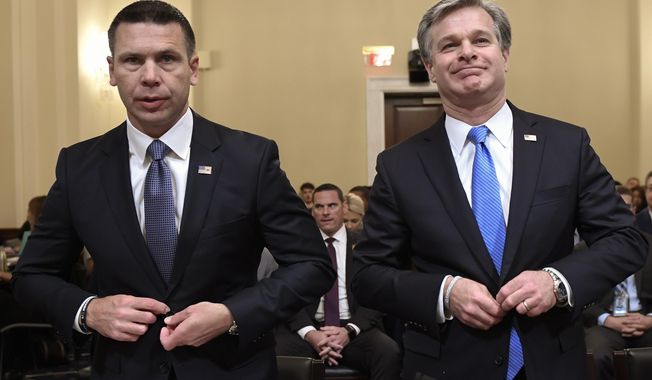 Acting Homeland Security Secretary Kevin McAleenan, left, and FBI Director Christopher Wray, right, prepare to testify before the House Homeland Security Committee on Capitol Hill in Washington, Wednesday, Oct. 30, 2019, during a hearing on domestic terrorism. (AP Photo/Susan Walsh)