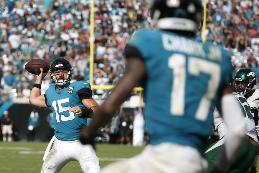 Jacksonville Jaguars quarterback Gardner Minshew II (15) throws a pass to wide receiver D.J. Chark (17) for a touchdown against the New York Jets during the second half of an NFL football game, Sunday, Oct. 27, 2019, in Jacksonville, Fla. (AP Photo/Stephen B. Morton)