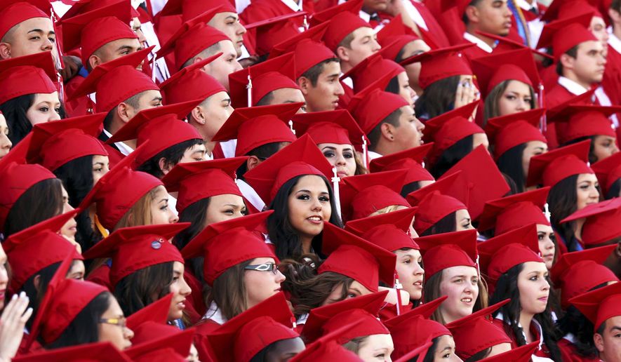 FILE - In this June 7, 2014, file photo, Odessa High School graduates pose for a group portrait prior to the start of the commencement ceremony in Odessa, Texas. Lower-performing students are doing worse in math and reading, dragging down overall results on the Nation’s Report Card. American fourth graders overall posted a slight decline in8 math and a slight gain in reading, while eighth graders saw results fall in both reading and math. That’s according to results released Wednesday on the 2019 National Assessment of Educational Progress, a nationwide test. (Edyta Blaszczyk/Odessa American via AP)