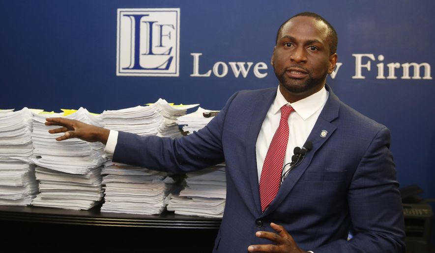 FILE - In this Aug. 29, 2019, file photo, Oklahoma state Rep. Jason Lowe, D-Oklahoma City, gestures to a stack of petitions during a news conference in Oklahoma City. An Oklahoma judge has rejected an attempt by a Democratic state lawmaker and gun safety advocates to stop a new law from taking effect that would allow most people in the state to carry a firearm in public without a background check or training. Oklahoma County District Judge Don Andrews on Wednesday, Oct. 30, rejected a request by Oklahoma City Rep. Lowe for a temporary injunction to stop the so-called "permitless carry" law from taking effect Friday. (AP Photo/Sue Ogrocki File)