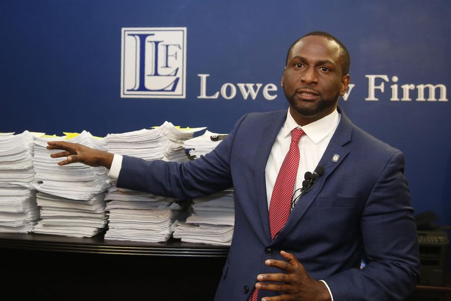 FILE - In this Aug. 29, 2019, file photo, Oklahoma state Rep. Jason Lowe, D-Oklahoma City, gestures to a stack of petitions during a news conference in Oklahoma City. An Oklahoma judge has rejected an attempt by a Democratic state lawmaker and gun safety advocates to stop a new law from taking effect that would allow most people in the state to carry a firearm in public without a background check or training. Oklahoma County District Judge Don Andrews on Wednesday, Oct. 30, rejected a request by Oklahoma City Rep. Lowe for a temporary injunction to stop the so-called "permitless carry" law from taking effect Friday. (AP Photo/Sue Ogrocki File)