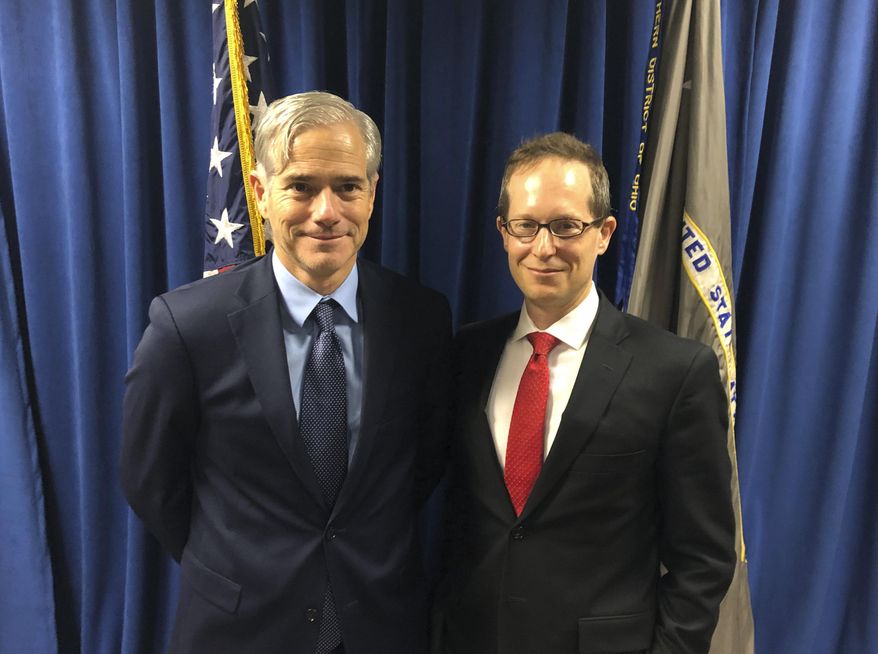 In this Tuesday, Oct. 29, 2018, photo David DeVillers, left, a veteran prosecutor confirmed this week by the U.S. Senate to become U.S. Attorney for southern Ohio, stands with current U.S. Attorney Benjamin C. Glassman in the federal prosecutor's offices in Cincinnati. Glassman, who steps down Friday, Nov. 1, discussed his hectic three years, including a deadly mass shooting this summer in Dayton, as head of the office during an interview with The Associated Press. (AP Photo/Dan Sewell)