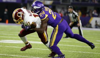 Washington Redskins wide receiver Terry McLaurin (17) is tackled by Minnesota Vikings cornerback Xavier Rhodes (29) after catching a pass during the first half of an NFL football game, Thursday, Oct. 24, 2019, in Minneapolis. (AP Photo/Bruce Kluckhohn)