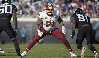 In this Dec. 16, 2018, file photo, Washington Redskins offensive tackle Trent Williams (71) sets up to block in front of Jacksonville Jaguars defensive end Yannick Ngakoue (91) during the second half of an NFL football game in Jacksonville, Fla. (AP Photo/Phelan M. Ebenhack) ** FILE **