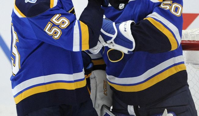 St. Louis Blues&#x27; Jordan Binnington (50) is congratulated by Colton Parayko (55) after the team&#x27;s 2-1 victory over the Minnesota Wild in an NHL hockey game Wednesday, Oct. 30, 2019, in St. Louis. (AP Photo/Bill Boyce)