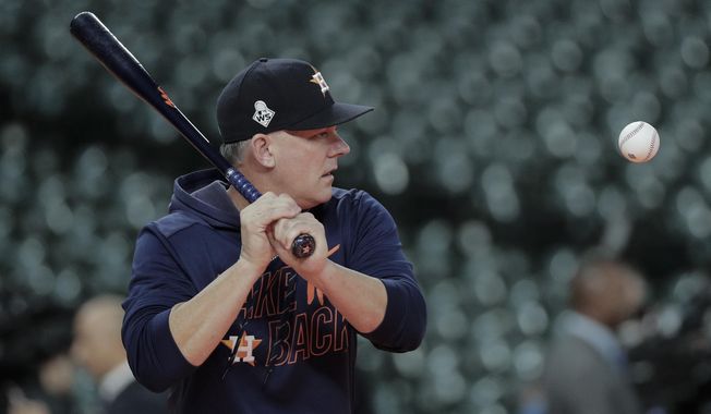 Houston Astros manager AJ Hinch hits balls during batting practice before Game 7 of the baseball World Series against the Washington Nationals Wednesday, Oct. 30, 2019, in Houston. (AP Photo/David J. Phillip)