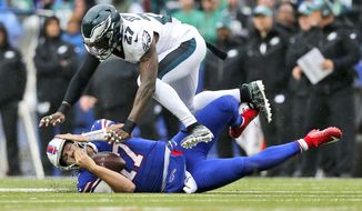Buffalo Bills quarterback Josh Allen, bottom, calls time-out as he slides under Philadelphia Eagles&#39; Malcolm Jenkins during the first half of an NFL football game, Sunday, Oct. 27, 2019, in Orchard Park, N.Y. (AP Photo/John Munson)