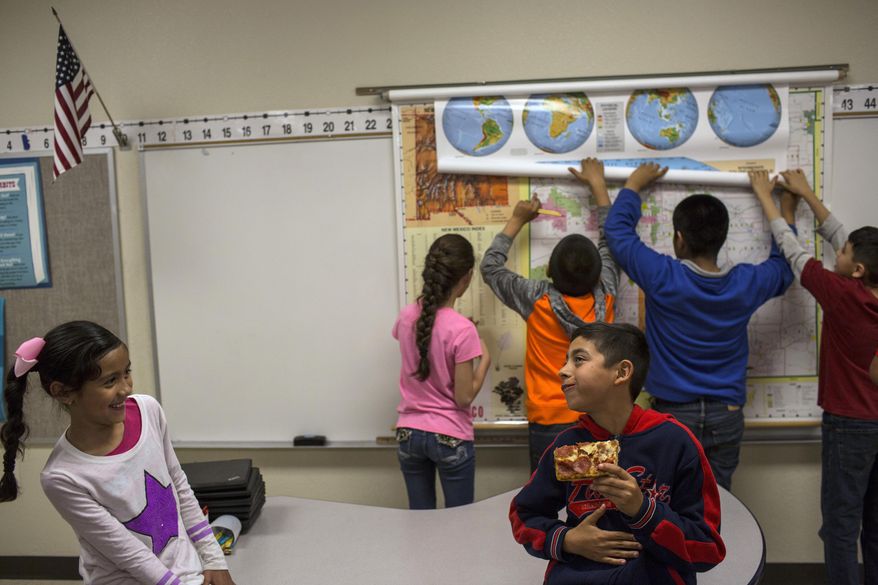 File - In this March 31, 2017, file photo, a student eats a slice of pizza during a break in a fourth grade classroom at Columbus Elementary School, in Columbus, N.M. New Mexico's fourth-grade and eighth-grade students' test scores in math and reading on the latest Nation's Report Card remain well below the national average, according to results released Wednesday, Oct. 30, 2019. (AP Photo/Rodrigo Abd, File)