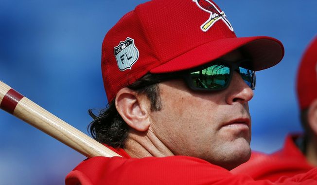 FILE - In this March 17, 2017, file photo, St. Louis Cardinals manager Mike Matheny (22) watches batting practice before a spring training baseball game against the New York Mets in Port St. Lucie, Fla. The Kansas City Royals have hired Matheny as manager on Thursday, Oct. 31, 2019. The 49-year-old Matheny was manager of the cross-state Cardinals from 2012-18, going 591-474 and becoming the first manager to reach the postseason his first four seasons.  (AP Photo/John Bazemore, File)