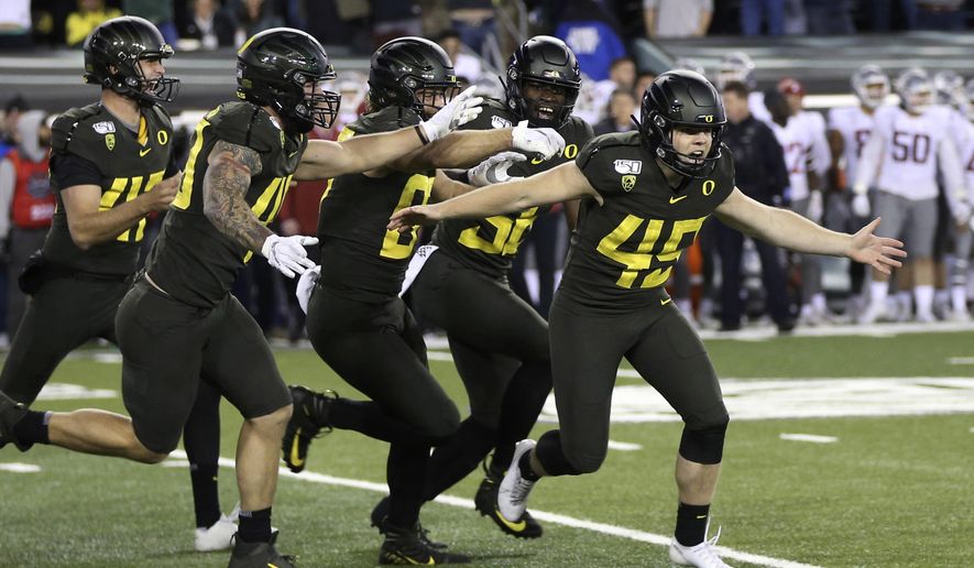 Oregon kicker Camden Lewis, right, begins the celebration after his game winning field goal against Washington State in an NCAA college football game Saturday, Oct. 26, 2019, in Eugene, Ore. (AP Photo/Chris Pietsch)