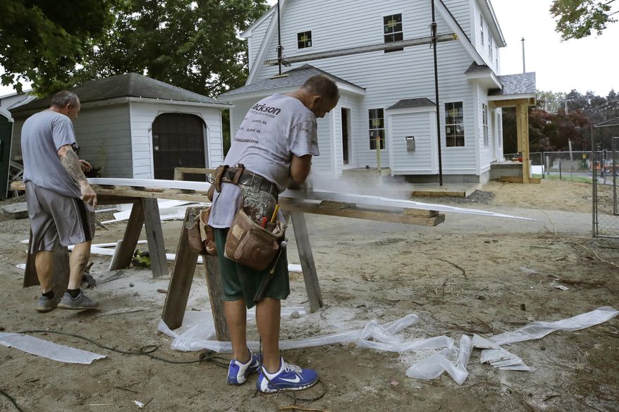 In this Oct. 2, 2019 photo, carpenters work on a construction site in North Andover, Mass. On Friday, Nov. 1, the Commerce Department reports on U.S. construction spending in September. (AP Photo/Elise Amendola)