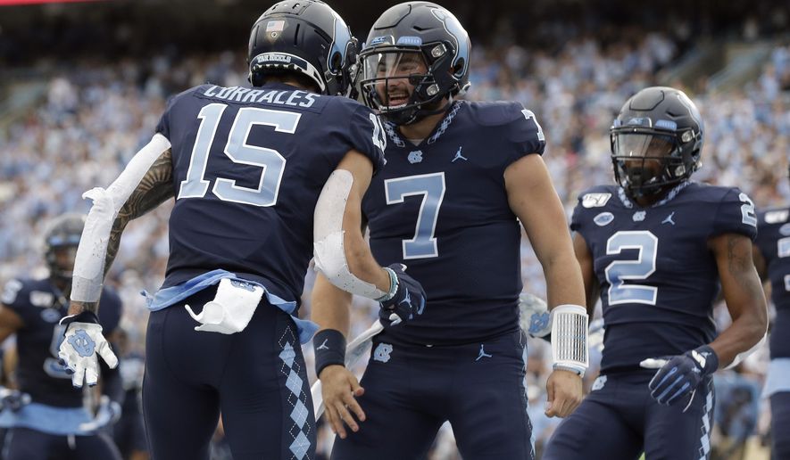 North Carolina quarterback Sam Howell (7) and wide receiver Beau Corrales (15) celebrate a touchdown against Duke during the first half of an NCAA college football game in Chapel Hill, N.C., Saturday, Oct. 26, 2019. (AP Photo/Gerry Broome)