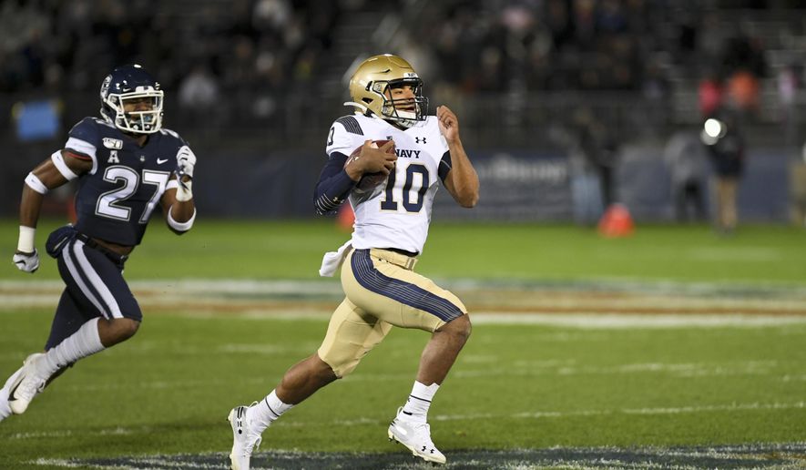 Navy quarterback Malcolm Perry (10) takes the ball in for Navy's first touchdown during the first half of an NCAA college football game against Connecticut on Friday, Nov. 1, 2019, in East Hartford, Conn. (AP Photo/Stephen Dunn)