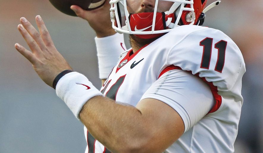 FILE - In this Oct. 5, 2019, file photo, Georgia quarterback Jake Fromm (11) throws to a receiver during warmups before an NCAA college football game against Tennessee, in Knoxville, Tenn. The SEC hasn't had a quarterback picked in the first round of the NFL draft since Johnny Manziel in 2014, and the league has never had more than one quarterback taken in the first round. It appears that's about to change, as Tua Tagovailoa, Joe Burrow and possibly Jake Fromm could make the next draft the best ever for SEC quarterbacks. (AP Photo/Wade Payne, File)