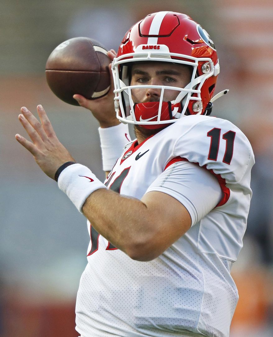 FILE - In this Oct. 5, 2019, file photo, Georgia quarterback Jake Fromm (11) throws to a receiver during warmups before an NCAA college football game against Tennessee, in Knoxville, Tenn. The SEC hasn't had a quarterback picked in the first round of the NFL draft since Johnny Manziel in 2014, and the league has never had more than one quarterback taken in the first round. It appears that's about to change, as Tua Tagovailoa, Joe Burrow and possibly Jake Fromm could make the next draft the best ever for SEC quarterbacks. (AP Photo/Wade Payne, File)