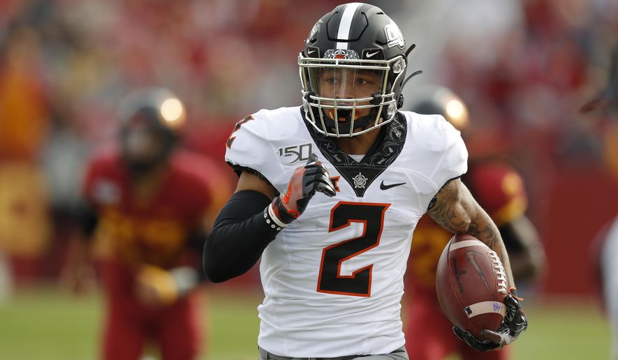 Oklahoma State wide receiver Tylan Wallace breaks free from Iowa State defense to score a touchdown during the first half of an NCAA college football game, Saturday, Oct. 26, 2019, in Ames, Iowa. (AP Photo/Matthew Putney)