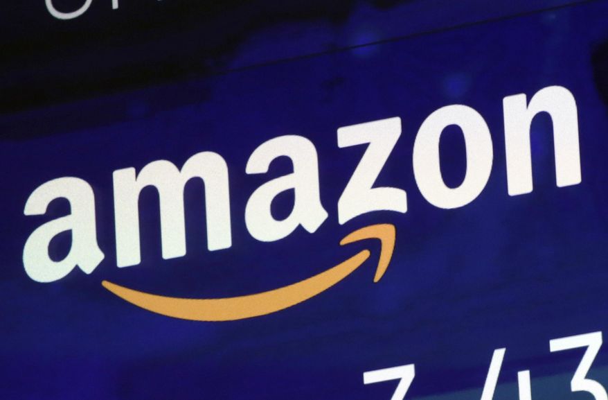 FILE - In this July 27, 2018 file photo, the logo for Amazon is displayed on a screen at the Nasdaq MarketSite in New York. Amazon must decide soon if it will protest the Pentagon’s awarding of a $10 billion cloud computing contract to rival Microsoft on Oct. 25, 2019, with one possible grievance being the unusual attention given to the project by President Donald Trump. Amazon was long thought to be the front-runner in the competition for the huge military contract. (AP Photo/Richard Drew, File)