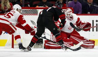 Carolina Hurricanes&#39; Andrei Svechnikov (37), of Russia, shoots the puck past Detroit Red Wings goaltender Jimmy Howard (35) during the first period of an NHL hockey game in Raleigh, N.C., Friday, Nov. 1, 2019. (AP Photo/Karl B DeBlaker)
