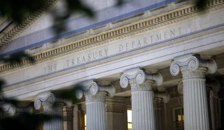 This June 6, 2019, file photo shows the U.S. Treasury Department building at dusk in Washington.  (AP Photo/Patrick Semansky, File) **FILE**