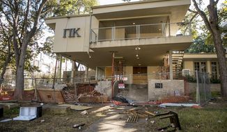 This Thursday, Oct. 31, 2019 photo shows The Pi Kappa Phi house in Austin, Texas.   The University of Texas chapter of the Pi Kappa Phi fraternity has been shut down following a university investigation into hazing allegations, the third such accusation the chapter has faced in eight years. The investigation revealed that during the 2018-19 school year fraternity pledges were shot with air soft guns and forced to eat spicy soup made with ghost peppers and cat food. The probe found that pledges competed in relay races where they ran back and forth between the chapter house and a nearby apartment building while chugging milk mixed with hand soap, laundry detergent or vinaigrette.  (Jay Janner/Austin American-Statesman via AP)