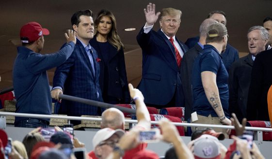Then-President Donald Trump and first lady Melania Trump, third from left, arrive for Game 5 of the World Series baseball game between the Houston Astros and the Washington Nationals at Nationals Park in Washington, Sunday, Oct. 27, 2019. Also pictured are Rep. Matt Gaetz, R-Fla., second from left, and Rep. Mark Meadows, R-N.C, right. (AP Photo/Andrew Harnik) ** FILE **