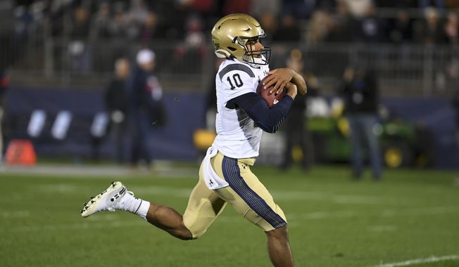 Navy quarterback Malcolm Perry (10) scores during the first half of an NCAA college football game against Connecticut Friday, Nov. 1, 2019, in East Hartford, Conn. (AP Photo/Stephen Dunn) **FILE**
