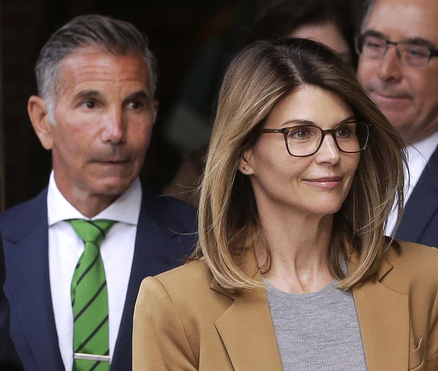 FILE - In this April 3, 2019, file photo, actress Lori Loughlin, front, and husband, clothing designer Mossimo Giannulli, left, leave federal court in Boston after facing charges in a nationwide college admissions bribery scandal. Lawyers for Loughlin and Giannulli filed court documents Friday, Nov. 1, saying the couple plans to plead not guilty to charges of conspiracy to commit federal program bribery. The couple also waived their right to appear at a Nov. 20 arraignment. (AP Photo/Steven Senne, File)
