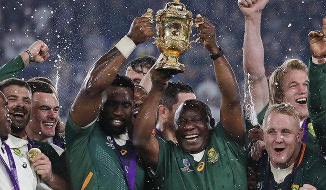 South African captain Siya Kolisi holds the Webb Ellis Cup aloft with South African President Cyril Ramaphosa after South Africa defeated England to win the Rugby World Cup final at International Yokohama Stadium in Yokohama, Japan, Saturday, Nov. 2, 2019. (AP Photo/Christophe Ena)