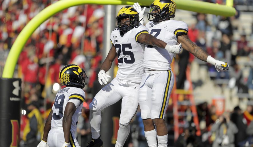 Michigan running back Hassan Haskins (25) celebrates his touchdown run against Maryland with wide receivers Tarik Black (7) and Mike Sainristil (19) during the second half of an NCAA college football game, Saturday, Nov. 2, 2019, in College Park, Md. Michigan won 38-7. (AP Photo/Julio Cortez)