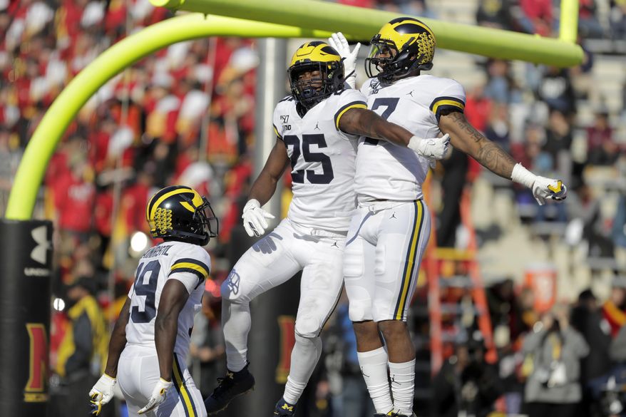 Michigan running back Hassan Haskins (25) celebrates his touchdown run against Maryland with wide receivers Tarik Black (7) and Mike Sainristil (19) during the second half of an NCAA college football game, Saturday, Nov. 2, 2019, in College Park, Md. Michigan won 38-7. (AP Photo/Julio Cortez)
