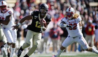 Wake Forest quarterback Jamie Newman (12) runs for a touchdown against North Carolina State in the first half an NCAA college football game in Winston-Salem, N.C., Saturday, Nov. 2, 2019. (AP Photo/Nell Redmond)