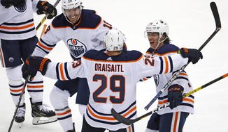 Edmonton Oilers&#39; Leon Draisaitl (29) celebrates his game-winning goal, with James Neal (18) and Ethan Bear, right, during the overtime period of an NHL hockey game against the Pittsburgh Penguins in Pittsburgh, Saturday, Nov. 2, 2019. The Oilers won 2-1. (AP Photo/Gene J. Puskar)