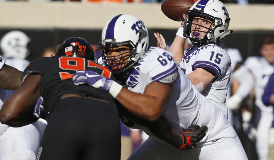 TCU quarterback Max Duggan (15) passes as offensive tackle Anthony McKinney (68) blocks Oklahoma State defensive tackle Amadou Fofana (97) in the first half of an NCAA college football game in Stillwater, Okla., Saturday, Nov. 2, 2019. (AP Photo/Sue Ogrocki)