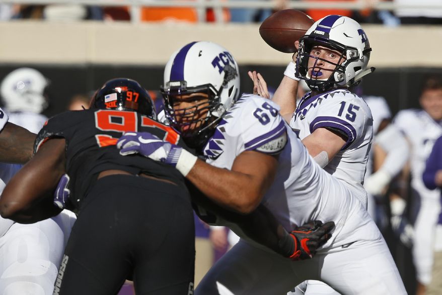 TCU quarterback Max Duggan (15) passes as offensive tackle Anthony McKinney (68) blocks Oklahoma State defensive tackle Amadou Fofana (97) in the first half of an NCAA college football game in Stillwater, Okla., Saturday, Nov. 2, 2019. (AP Photo/Sue Ogrocki)