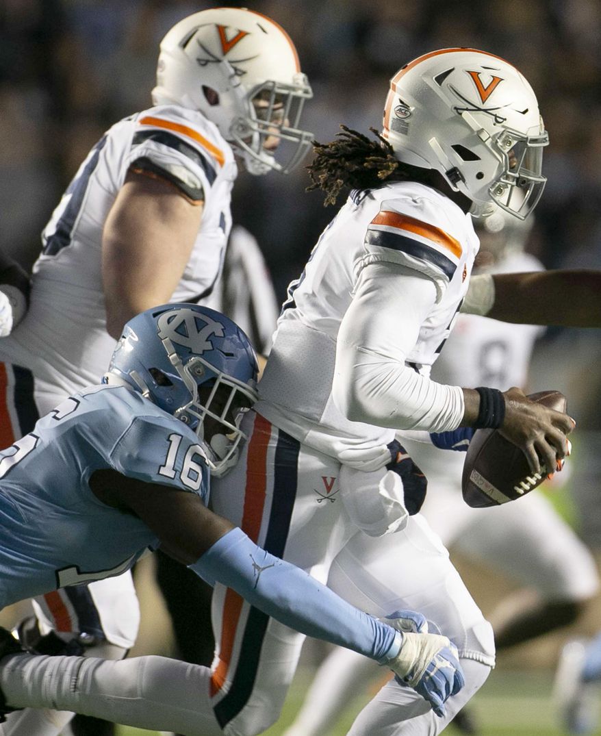 Virginia quarterback Bryce Perkins (3) is sacked by North Carolina's D.J. Ford on third down for a 7-yard loss during the second quarter of an NCAA college football game Saturday, Nov. 2, 2019, in Chapel Hill, N.C. (Robert Willett/The News & Observer via AP)