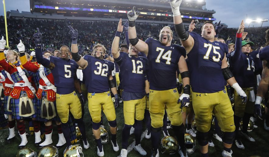 Members of the Notre Dame football team sing at the end of an NCAA college football game against Virginia Tech, Saturday, Nov. 2, 2019, in South Bend, Ind. Notre Dame won 21-20. (AP Photo/Carlos Osorio)