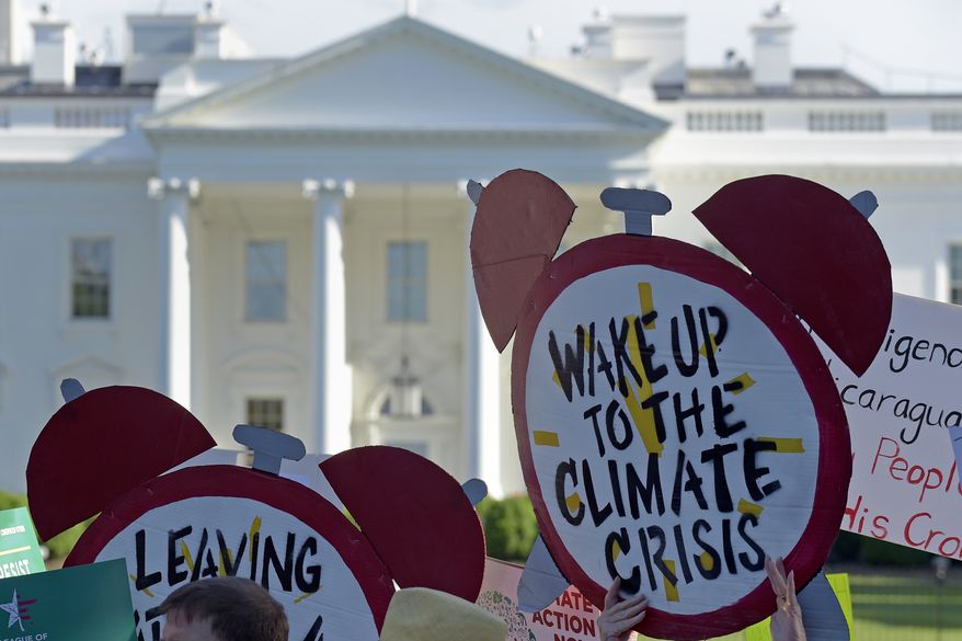 In this June 1, 2017, photo, protesters gather outside the White House in Washington to protest President Donald Trump&#x27;s decision to withdraw the United States from the Paris climate change accord. (AP Photo/Susan Walsh) **FILE**