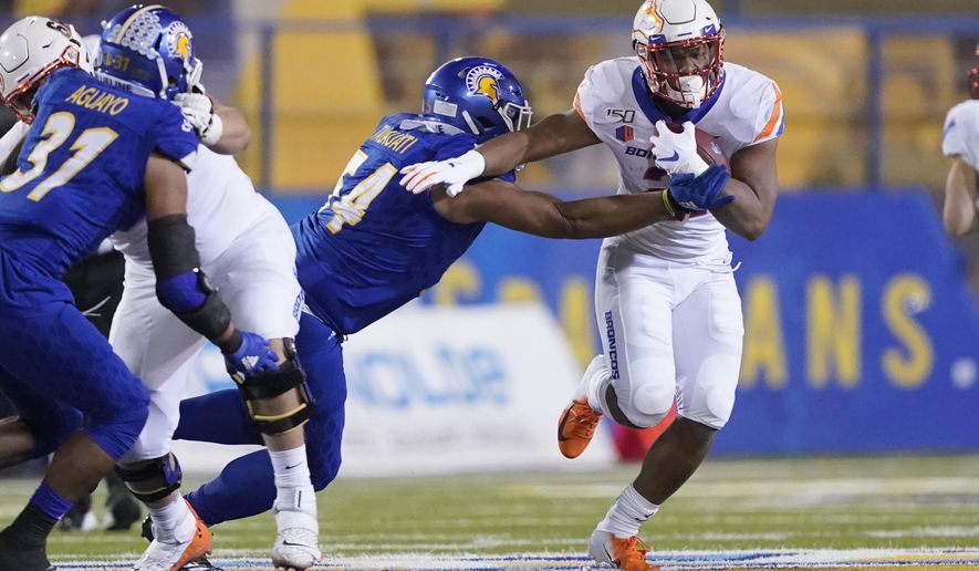 Boise State running back Andrew Van Buren (21) breaks a tackle by San Jose State defensive lineman Demanuel Talauati (54) during the first half of an NCAA college football game, in San Jose, Calif., Saturday, Nov. 2, 2019. (AP Photo/Tony Avelar)