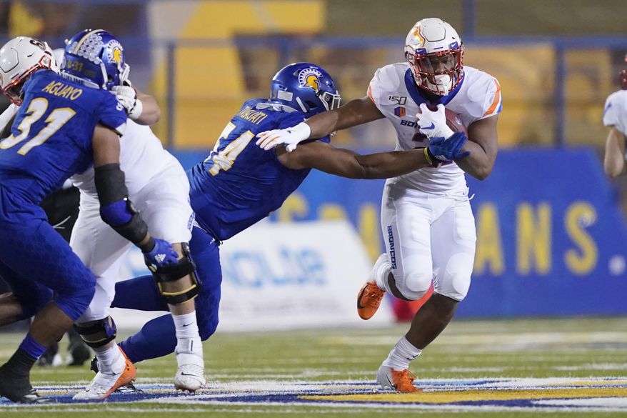 Boise State running back Andrew Van Buren (21) breaks a tackle by San Jose State defensive lineman Demanuel Talauati (54) during the first half of an NCAA college football game, in San Jose, Calif., Saturday, Nov. 2, 2019. (AP Photo/Tony Avelar)