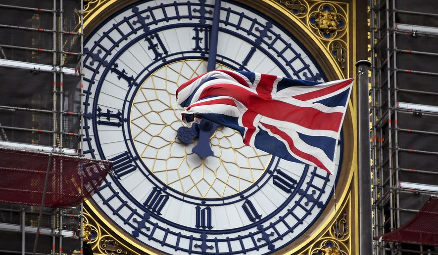 A Union flag waves against the backdrop of the clock facade of the Elizabeth Tower, which holds the bell known as “Big Ben”, in London, Friday, Nov. 1, 2019. British euroskeptic politician Nigel Farage is trying to ramp up the pressure on Conservative Prime Minister Boris Johnson. He warned that his Brexit Party will run against the Conservatives across the country in the Dec. 12 general election unless Johnson abandons his divorce deal with the European Union. (AP Photo/Alberto Pezzali)