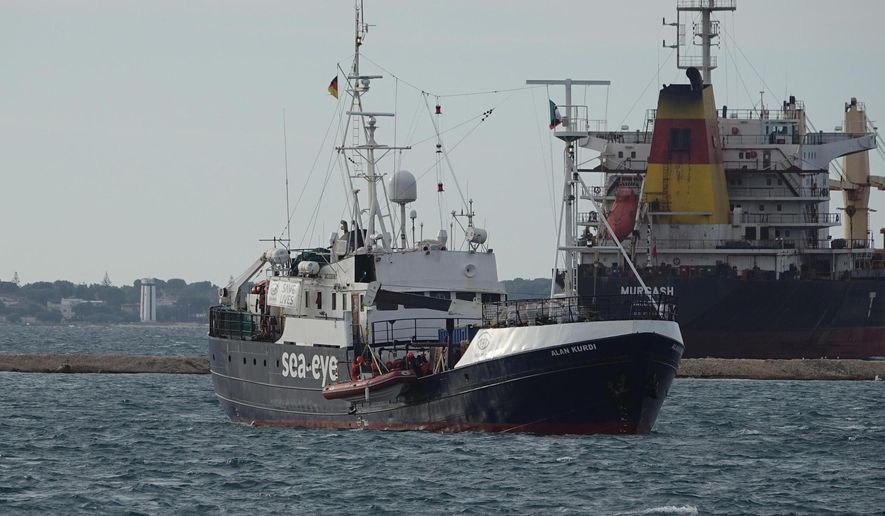 The Alan Kurdi rescue ship arrives into the port of Taranto, Italy, Sunday, Nov. 3, 2019. 88 people, rescued in the Mediterranean Sea north of Libya, disembarked Sunday from the Alan Kurdi, a ship operated by the Germany Sea-Eye humanitarian group. (Renato Ingenito/ANSA via AP)