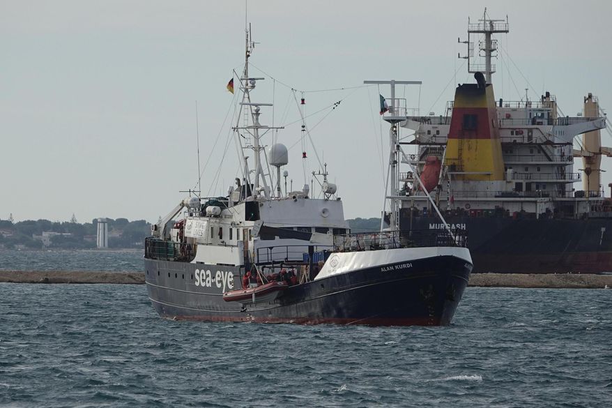 The Alan Kurdi rescue ship arrives into the port of Taranto, Italy, Sunday, Nov. 3, 2019. 88 people, rescued in the Mediterranean Sea north of Libya, disembarked Sunday from the Alan Kurdi, a ship operated by the Germany Sea-Eye humanitarian group. (Renato Ingenito/ANSA via AP)