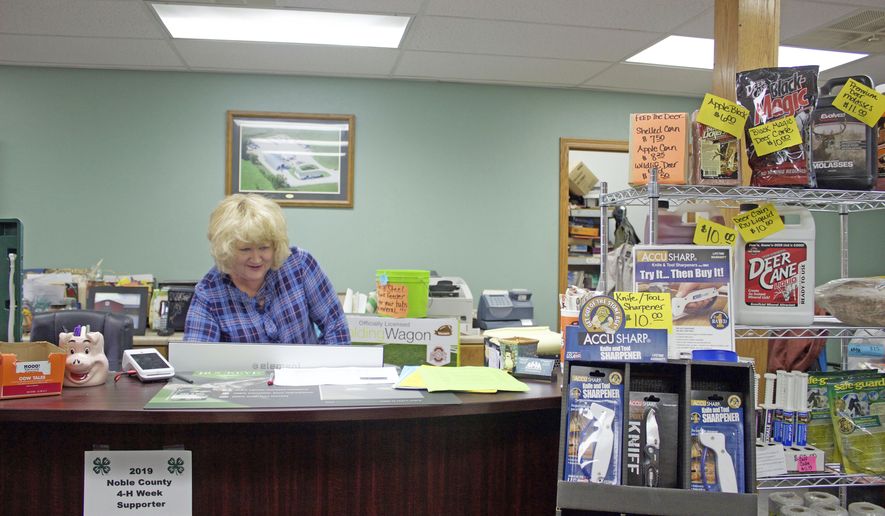 Darlene Miser works behind the counter of MM Feed Supply, in Pleasant City, Ohio, on Oct. 30, 2019. The feed supply store added broadband about five years ago to meet business demands. While the addition helped in some ways, speeds have slowed. After spending $30,000 to date for internet, Miser said they are unsure what the future holds when their contract ends. (Sarah Donkin/Farm and Dairy, Salem, Ohio via AP)