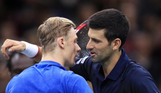 Novak Djokovic of Serbia greets Denis Shapovalov of Canada, left, after winning the final match of the Paris Masters tennis tournament in Paris, Sunday, Nov. 3, 2019. Djokovic defeated Shapovalov of Canada 6-3/6-4. (AP Photo/Michel Euler)