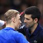 Novak Djokovic of Serbia greets Denis Shapovalov of Canada, left, after winning the final match of the Paris Masters tennis tournament in Paris, Sunday, Nov. 3, 2019. Djokovic defeated Shapovalov of Canada 6-3/6-4. (AP Photo/Michel Euler)