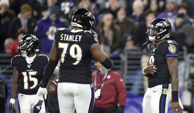 Baltimore Ravens quarterback Lamar Jackson (8) celebrates his touchdown run against the New England Patriots with offensive tackle Ronnie Stanley (79) during the first half of an NFL football game, Sunday, Nov. 3, 2019, in Baltimore. (AP Photo/Gail Burton)