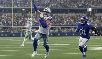 FILE - In this Sept. 8, 2019 file photo, Dallas Cowboys tight end Jason Witten (82) celebrates catching a touchdown pass as New York Giants defensive back Michael Thomas (31) defends in the first half of a NFL football game in Arlington, Texas. Witten is returning to Monday Night Football in his more accustomed role as the Dallas Cowboys’ tight end and not a television analyst for the ESPN production. Witten didn’t know if ESPN asked to have him miked for the game, but wanted no part of it. He said he has done it before and he didn’t like. His focus this week is to help the Cowboys build for their big win over the Eagles two weeks ago. (AP Photo/Ron Jenkins, File)