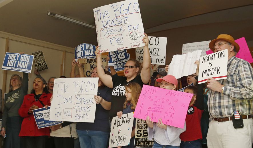 In this Monday, Feb. 25, 2019 file photo, abortion opponents cheer for a speaker at a rally at the state Capitol in Oklahoma City. The Oklahoma Supreme Court has blocked temporarily, a ban on a second-trimester abortion procedure. The high court acted Monday, Nov. 4, 2019, after an Oklahoma abortion clinic appealed a lower court judge's decision to uphold a ban on a second-trimester abortion procedure.(AP Photo/Sue Ogrocki, File) **FILE**